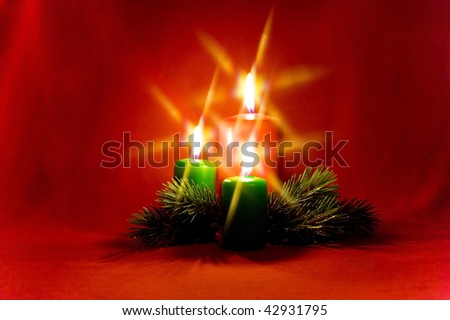 Burning candle with Christmas decorations of the cross filter effect