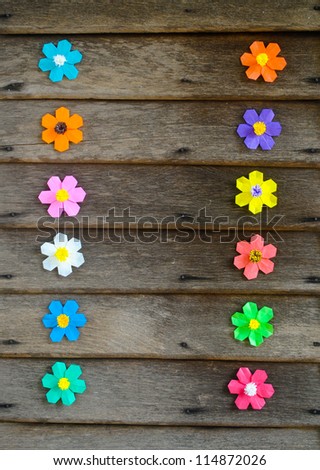 Colorful origami flower on wooden wall, thailand