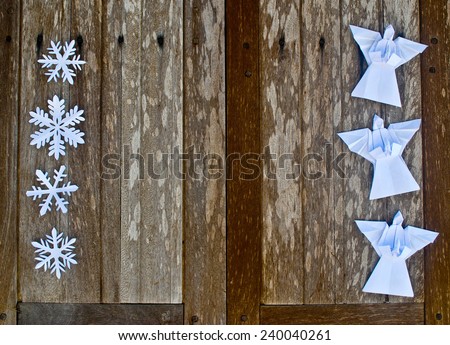Merry Christmas card with Angels and snowflake decorations in paper cutting origami style