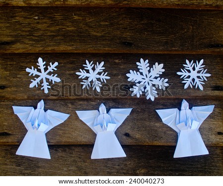 Merry Christmas card with Angels and snowflake decorations in paper cutting and origami style