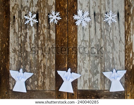 Merry Christmas card with Angels and snowflake decorations in paper cutting and origami style