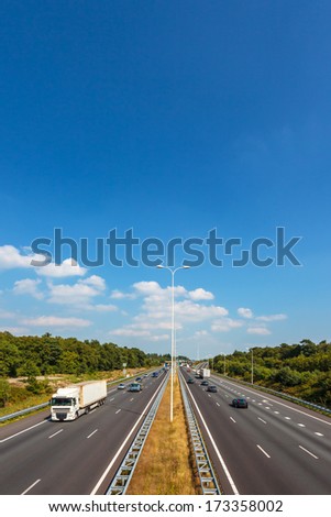 Multiple lane highway in The Netherlands against a blue sky with few clouds