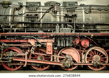 Retro styled side view of an old rusted steam locomotive