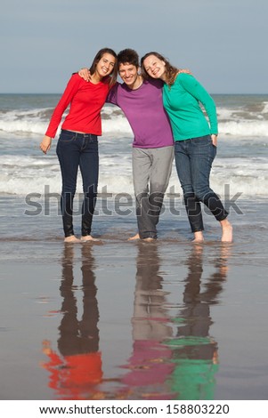 group of happy youth at the beach