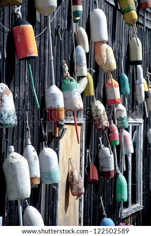 A wall full of colorful lobster buoys on Mount Desert Island in Maine