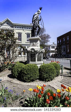 Flowers brighten the Lawrence the Indian statue in the stockade section of Schenectady, NY