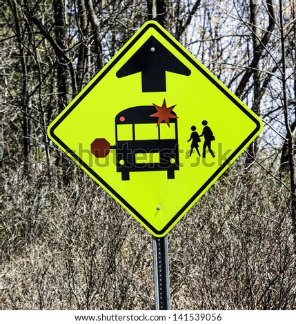 A school bus stop traffic sign