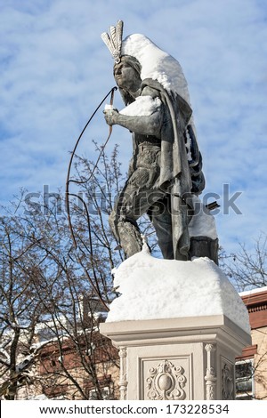 Snow covers the upper portion of Lawrence the Indian, a landmark statue in the Stockade section of Schenectady, New York. Lawrence was instrumental in the re-building of Schenectady after the village.