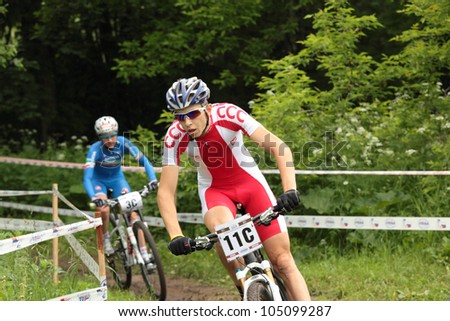MOSCOW, RUSSIA - JUNE 7: Marek Konwa (Poland) followed by Eva Lechner (Italy) in team relay during European Mountain Bike Cross-country Championship in Moscow, Russia at June 7, 2012.
