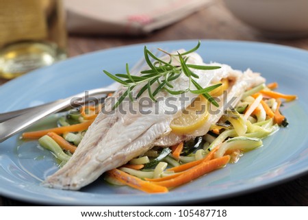 Baked sea bass on a bed of roasted vegetables