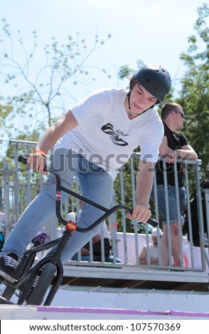 MOSCOW, RUSSIA - JULY 8: Unidentified street rider in BMX warm-up during Adrenalin Games in Moscow, Russia on July 8, 2012