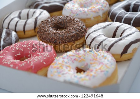 Assorted sweet donuts in a paper box