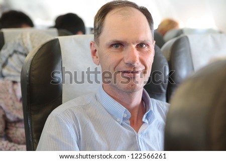 Mature man in the aircraft seat