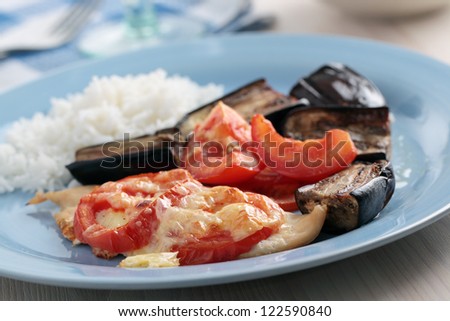 Baked chicken breasts with tomato, mozzarella cheese, aubergines, and rice