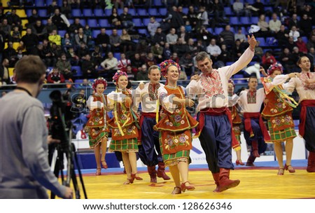 KIEV, UKRAINE - FEBRUARY 16: Folklore dance group Perlyna dances the hopak on opening ceremony of International freestyle wrestling and female wrestling tournament in Kiev,Ukraine on February 16, 2013
