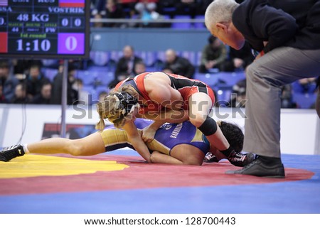 KIEV, UKRAINE - FEBRUARY 16: Final match between Lampe, USA, red and Vostrikova, Russia during International freestyle wrestling and female wrestling tournament in Kiev, Ukraine on February 16, 2013