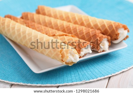Gaufres de Montcuq, rolled wafers with cream filling  on a white dish