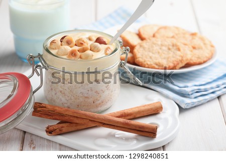 Overnight oats with cinnamon, hazelnuts, mango yogurt, and Swedish oatmeal cookies