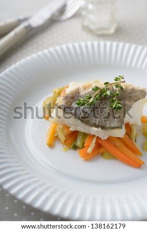 Baked cod on vegetable bed