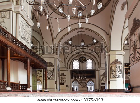 BURSA, TURKEY - AUGUST 20: People in the Ulu Camii (Grand mosque) in Bursa, Turkey on August 20, 2011. Built in the Seljuk style between 1396 and 1399, the mosque has 20 domes and 2 minarets
