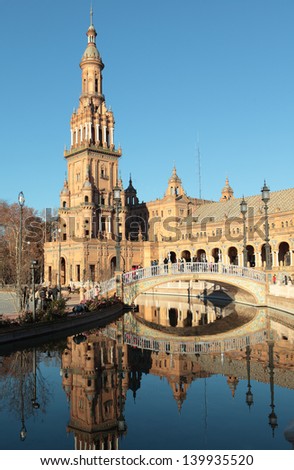 SEVILLE, SPAIN - JANUARY 3: People walking on Plaza de Espana in Seville, Spain on January 3, 2012. Built in 1928, it\'s a landmark example of the Renaissance Revival style in Spanish architecture