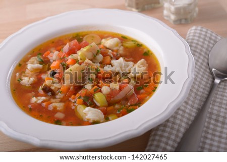 Fish soup with vegetables closeup