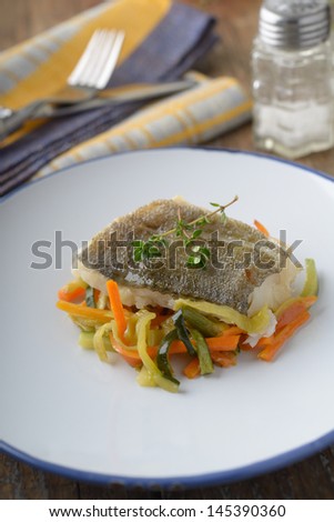 Baked cod on vegetable bed