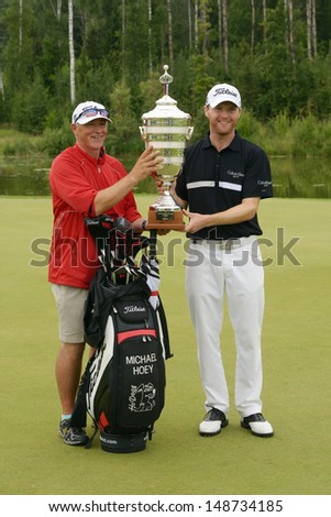 MOSCOW, RUSSIA - JULY 28: Michael Hoey of Northern Ireland and his caddie with the trophy of the M2M Russian Open at Tseleevo Golf & Polo Club in Moscow, Russia on July 28, 2013