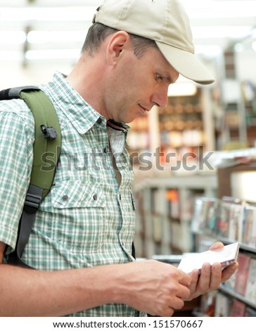 Man selecting the movie in a shop