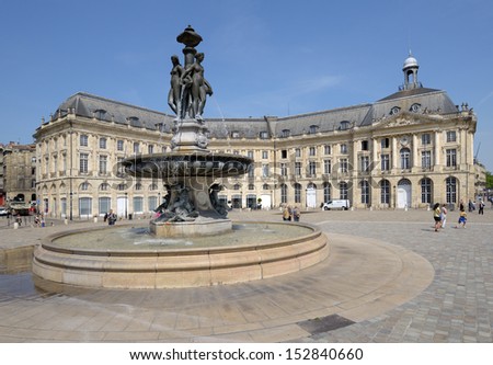 BORDEAUX, FRANCE - JUNE 27: People walks on the Place de la Bourse in Bordeaux, France on June 27, 2013. The fountain of Three Graces in the center of square was erected in 1869