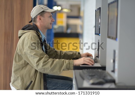 Man using public internet access point in airport