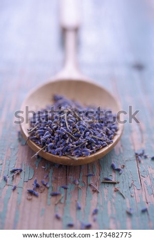 Dried lavender flowers in a bamboo spoon. Selective focus