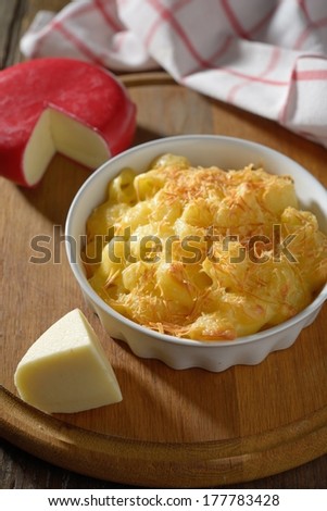 Macaroni and cheese in a baking dish on a cutting board