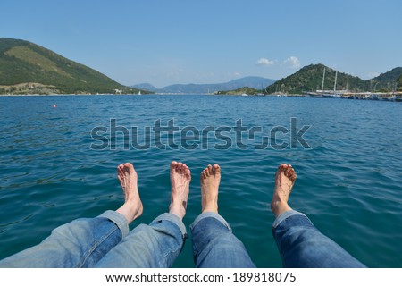 Bare feet of a couple against the sea