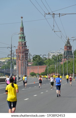 MOSCOW, RUSSIA - MAY 18, 2014: Runners on the distance of Moscow Half Marathon against Kremlin walls. It is the second race of the Moscow Marathon race series