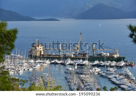 MARMARIS, TURKEY - MAY 2, 2014: Unloading yachts from the ship. Marmaris yacht marina is one of the biggest in Turkey with spaces for 650 boats on pontoon berths and over 1000 on the hard standing
