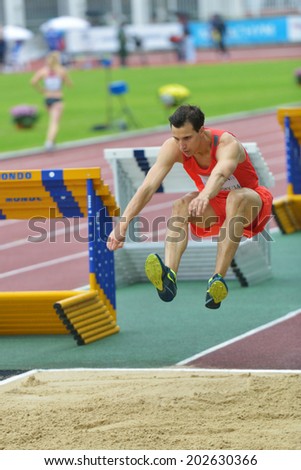 ZHUKOVSKY, MOSCOW REGION, RUSSIA - JUNE 27, 2014: Karol Hoffmann of Poland performs triple jump during Znamensky Memorial. The competitions is one of the European Athletics Outdoor Classic Meetings