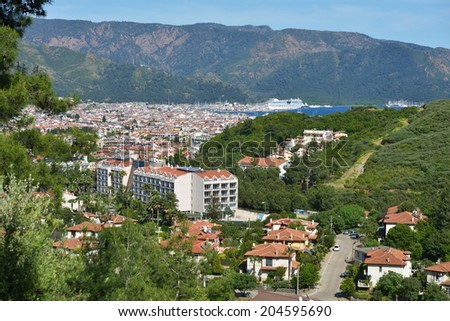 MARMARIS, TURKEY - APRIL 17, 2014: Cityscape of Marmaris with the cruise liner AIDAdiva anchored in port. AIDA ships cater to the German-speaking market, and has 94% average guests satisfaction rate