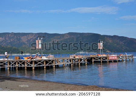 MARMARIS, TURKEY - APRIL 21, 2014: People resting in the lounge bar on the pier. City population increases 10 times during the tourism season, and its nightlife rivals anything on the Turkish coast
