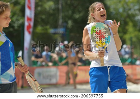 MOSCOW, RUSSIA - JULY 20, 2014: Women double of Portugal in the match against Japan during ITF Beach Tennis World Team Championship. Japan won in two sets