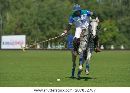 TSELEEVO, MOSCOW REGION, RUSSIA - JULY 26, 2014: Esteban Panelo of Moscow Polo club in action in the match against the team of British Schools during the British Polo Day. Moscow Polo Club won 7-6