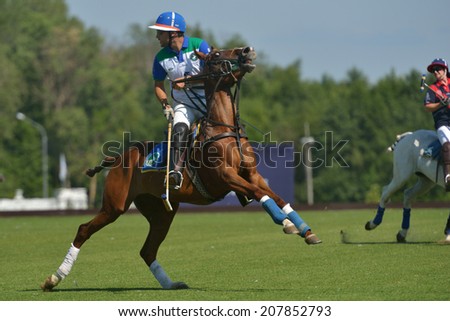 TSELEEVO, MOSCOW REGION, RUSSIA - JULY 26, 2014: Misha Rodzianko of Moscow Polo Club in action in the match against British Schools during the British Polo Day. Moscow Polo Club won 7-6