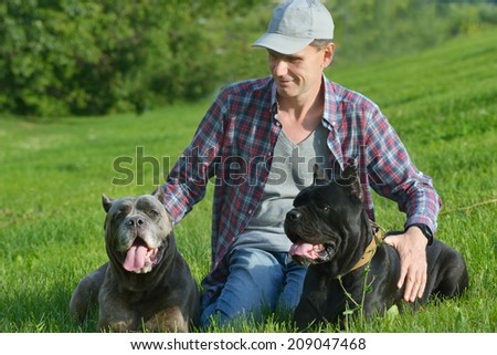 Man playing with his dogs in the park