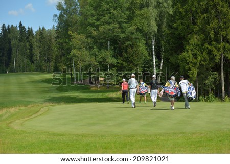TSELEEVO, MOSCOW REGION, RUSSIA - JULY 26, 2014: Golfers on the golf course in the Tseleevo Golf & Polo Club during the M2M Russian Open. This golf tournament is the stage of the European Tour