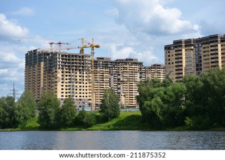 DOLGOPRUDNY, MOSCOW REGION, RUSSIA - JULY 4, 2014: Construction of new residential buildings on the banks of Moscow canal. About 4 millions square meters of housing built in Moscow annually