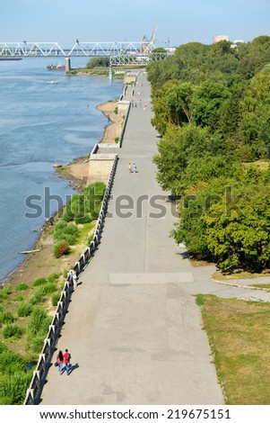 NOVOSIBIRSK, RUSSIA - AUGUST 24, 2014: People walking on the embankment of Ob river in the park \