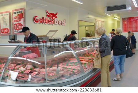 SARLAT, FRANCE - JUNE 28, 2013: People buy meat in the butcher shop Golden Beef. The shop has branches in Limoges, Brive, and Saint-Junien