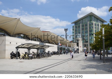 POITIERS, FRANCE - JUNE 26, 2013: People and bike parking in front of the train station. The station is situated on the Paris Bordeaux railway which was built in 1853
