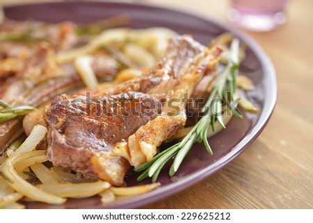 Lamb cutlet with onion and rosemary. Selective focus