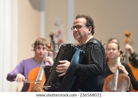 NOVOSIBIRSK, RUSSIA - DECEMBER 8, 2014: French accordionist Richard Galliano on the rehearsal with chamber orchestra during the festival Classics. The event joins the concert of the World music stars